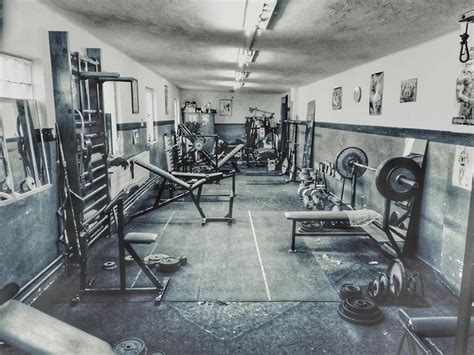 an old photo of a gym room with equipment on the walls and floor, in ...