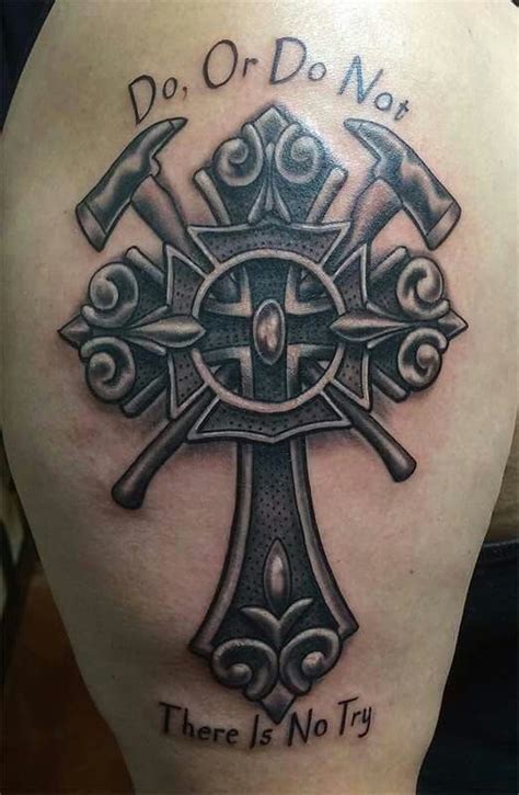 the back of a woman's shoulder with an ornate cross and hammers on it