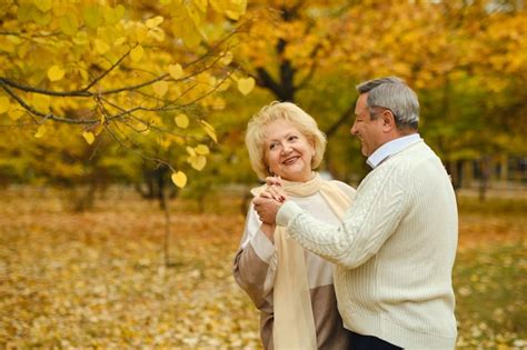 Premium Photo | Active happy seniors dancing in autumn park