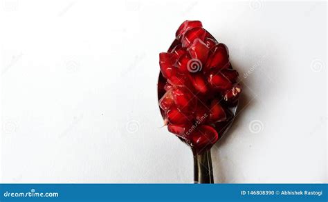 Pomegranate on Spoon. Pomegranate Seeds on Spoon on White Stock Photo ...