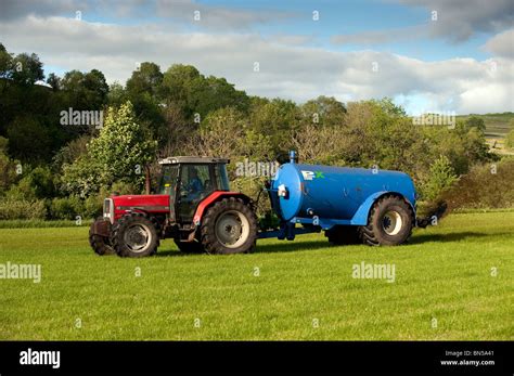 Slurry spreading with a vacum tanker on back of a Massey Ferguson 6180 Stock Photo - Alamy