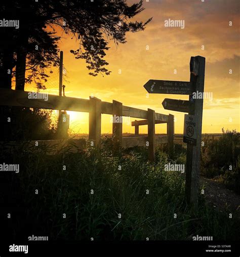 Brancaster Staithe on Norfolk coastal footpath at sunset Stock Photo - Alamy