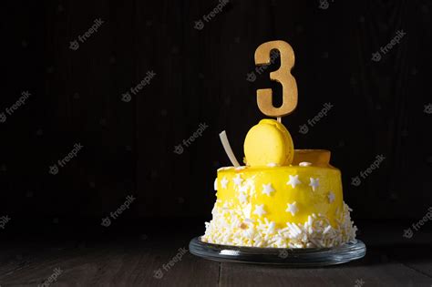 Premium Photo | The number three on a yellow cake for an anniversary or ...