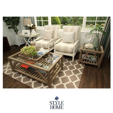 a living room with two couches and a coffee table in front of a window