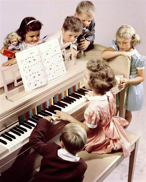 A Group Of Children At The Piano by Herbert Matter