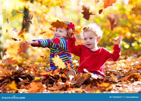 Kids Playing in Autumn Park Stock Image - Image of beautiful, october: 76256221