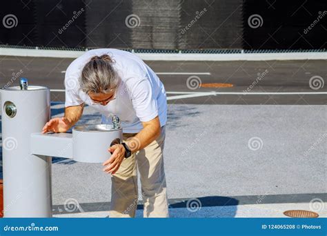 Man Drinking Water from Drinking Fountain at Street. Stock Photo ...