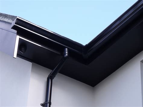 Installation of Black Fascias, Soffits and Seamless Aluminium Guttering in Cheam, Surrey ...