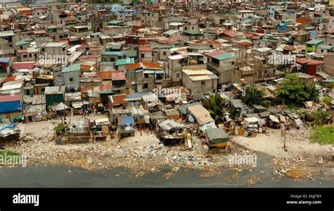 Slums in Manila near the port. River polluted with plastic and garbage ...