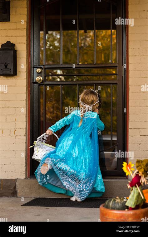 Trick or treating in costumes on Halloween night Stock Photo - Alamy