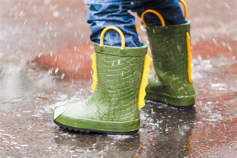 Child with Rain Boots Jumps into a Puddle Stock Photo - Image of splashing, rain: 127238676