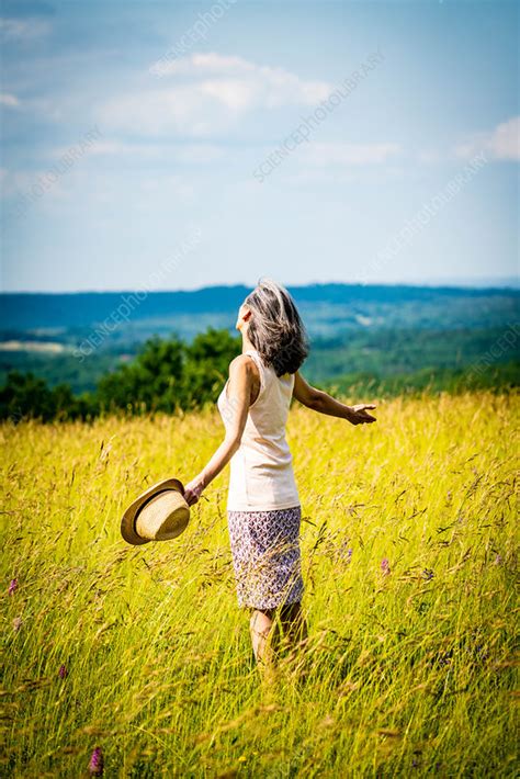 Woman relaxing in nature - Stock Image - C047/8971 - Science Photo Library