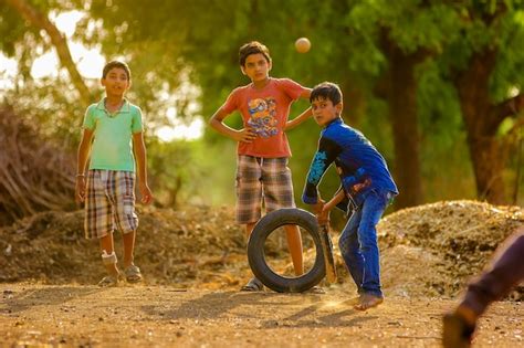 Premium Photo | Rural Indian Child Playing Cricket on ground