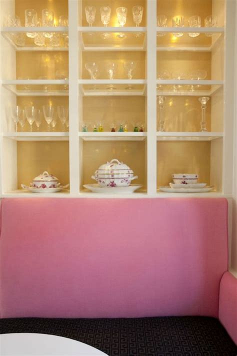 pink & black dining banquette | glass shelf display. love the gilded back of the cabinets ...