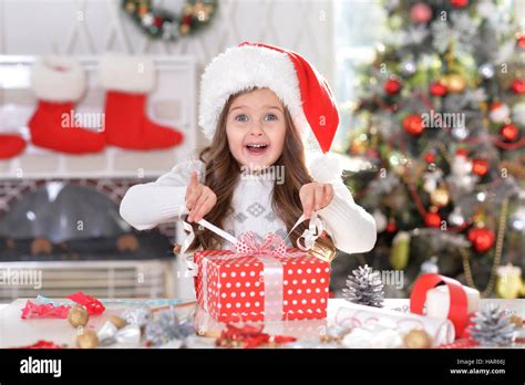 Little girl with Christmas gift Stock Photo - Alamy