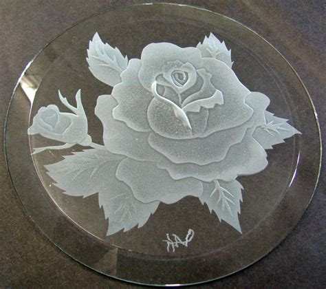 a glass plate with a rose etched on it