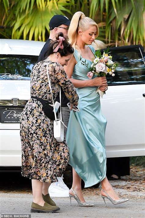 Paris Hilton wore a light blue satin maxi dress as she attended Lele Pons’ wedding in Miami ...