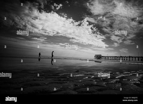 Two People Walking On Beach Stock Photo - Alamy