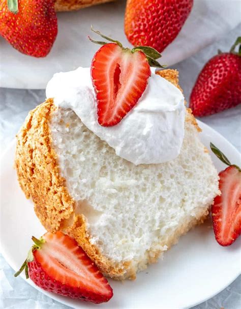 a piece of cake with whipped cream and strawberries