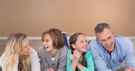 Family Laughing Together Having Fun with Orange Wall in Room Stock ...