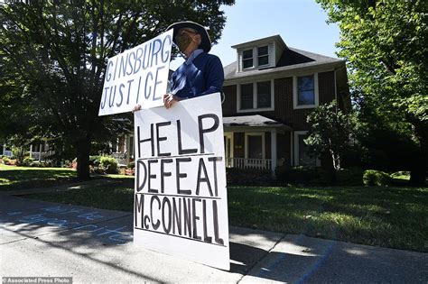 Protesters gather outside Mitch McConnell's Kentucky home to demand he stop pushing forward with ...