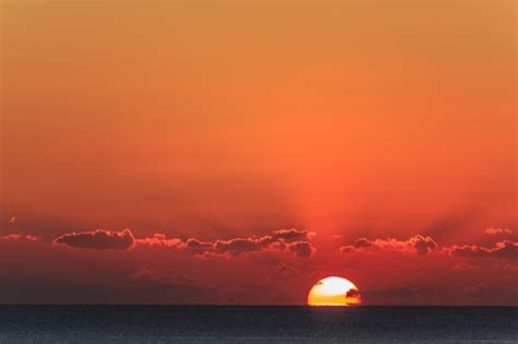 Premium Photo | Sunset at sea with dramatic clouds.