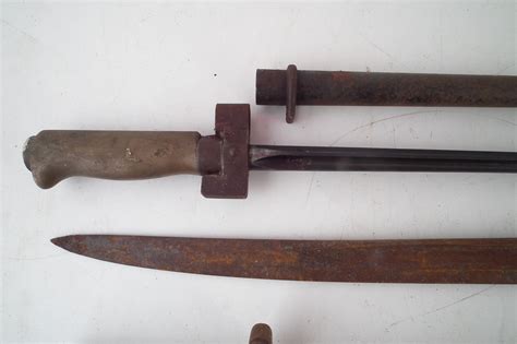 Lot 190 - Four French bayonets and a socket bayonet