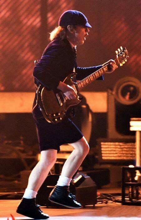 Angus in School boy (on stage) attire. | Angus young, Acdc angus young, Acdc angus