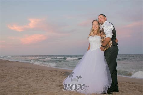 Beautiful Sunset wedding on the Ocean City MD beach: https://www.oceancitybeachwedding.com ...