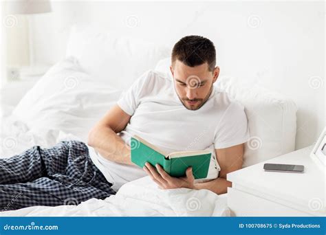 Man Reading Book in Bed at Home Stock Image - Image of happy, lifestyle ...