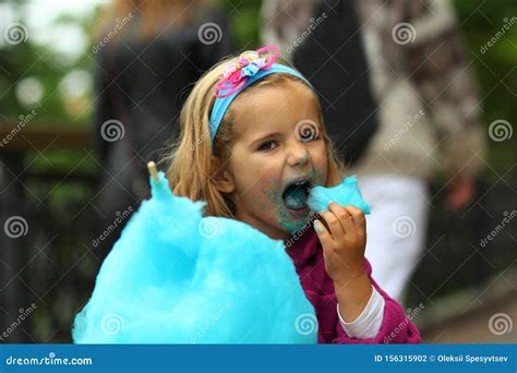 Closeup Portrait of Happy Toddler Girl Eating Blue Cotton Candy Stock ...