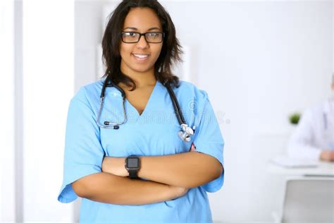 Female African American Medical Doctor with Colleagues in Background ...