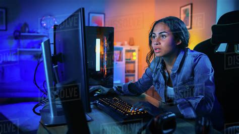 Pretty and excited black gamer girl has a tense moment in her first-person online shooter video ...