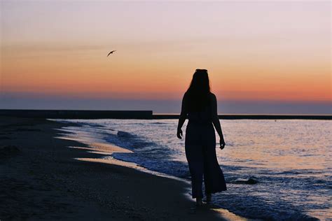 HD wallpaper: woman silhouette on beach shore during golden hour ...