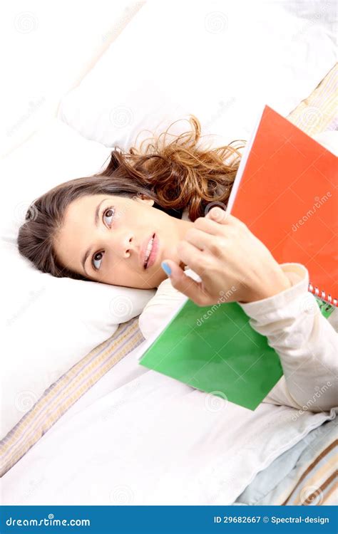 Reading a Book in Bed stock image. Image of brunette - 29682667