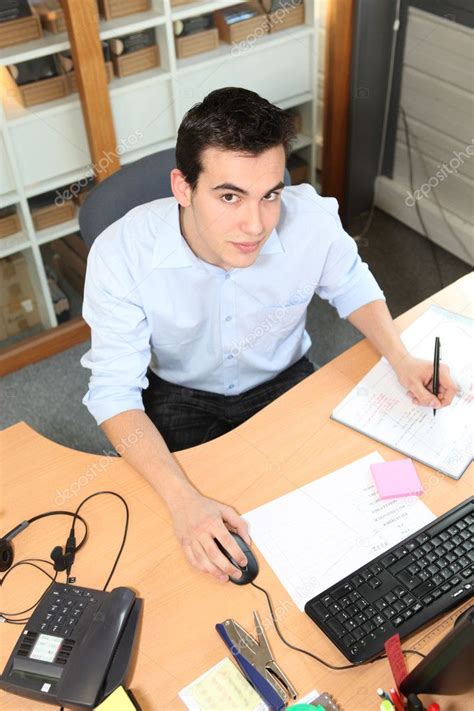 Young man working at an office desk — Stock Photo © photography33 #7701256