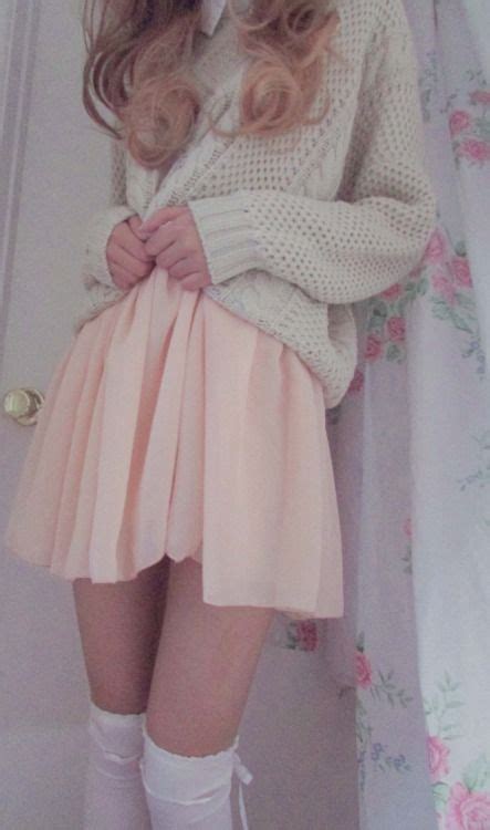 Knitted, grey sweat over a light pink skirt with white thigh highs ...