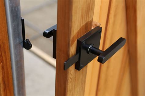 two wooden doors with metal handles on each side and one has a black ...