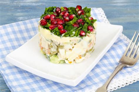 Served salad decorated with greens and pomegranate seeds. 4518911 Stock ...