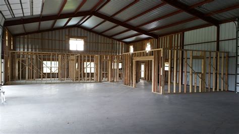 Wood framing the inside first floor | Pole barn house cost, Pole barn homes, House cost