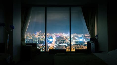 Night city skyline view dark empty room with panoramic window 4K UHD ...