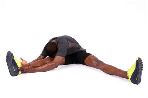 Fitness Man Doing Head To Knee Stretch While Sitting on The Floor - High Quality Free Stock Images