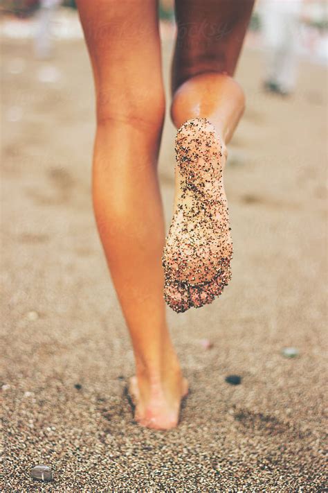 "Female Feet On The Beach Covered In Sand" by Stocksy Contributor "Jovana Rikalo" - Stocksy