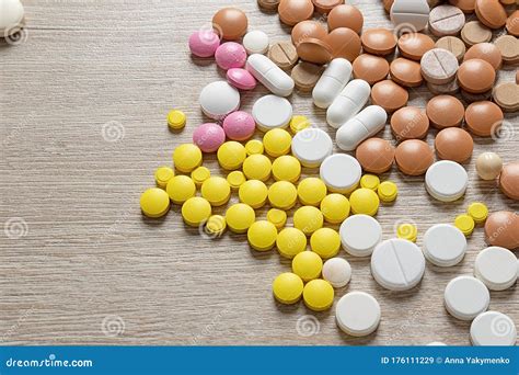 Tablets of Various Shapes and Colors Scattered on the Table . Pills ...