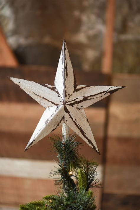 a wooden star ornament hanging from a christmas tree