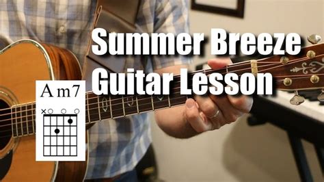 a man holding an acoustic guitar with the words summer breeze guitar lesson