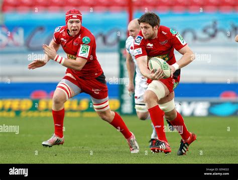 Llanelli Scarlets' Richard Kelly supported by Kieran Murphy breaks away ...