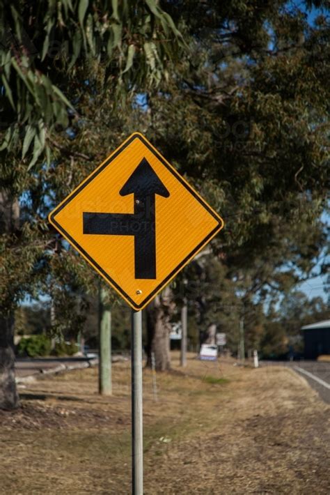 Image of Side road ahead to the left road sign - Austockphoto