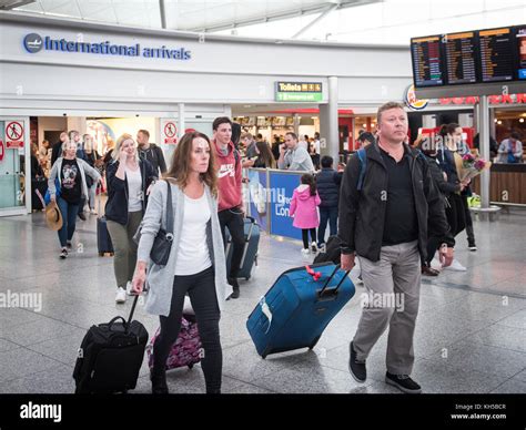 People arriving into UK via International Arrivals at Stansted Airport Stock Photo - Alamy