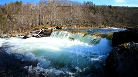 Nature sound of a loud waterfall flowing down the wet forest